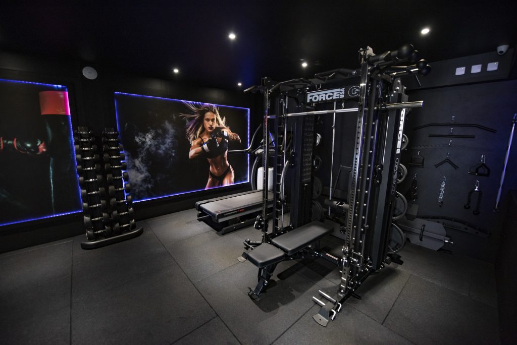 Private gym Smith machine, treadmill and dumbbell rack.