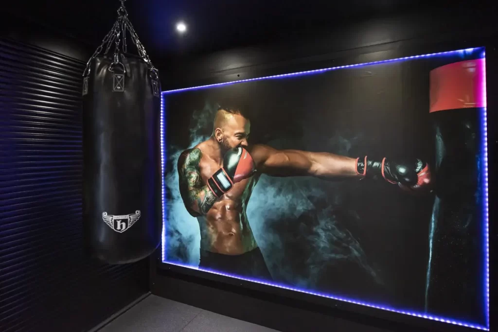 Boxing training in private gym Bromley with punching bag and strength conditioning equipment